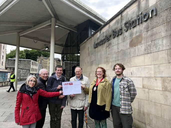 group of people standing outsiden the bus station