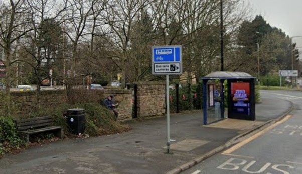 a bus shelter at the side of the road